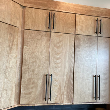Angled Kitchen Design with Slab Style Cabinets in Pecan Stain