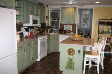 Elegant ceramic tile kitchen photo in Nashville with a drop-in sink, recessed-panel cabinets, green cabinets, concrete countertops, metallic backsplash, metal backsplash, white appliances and an island