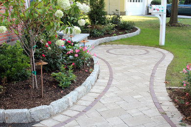 Photo of a mid-sized contemporary partial sun front yard stone landscaping in Boston for spring.