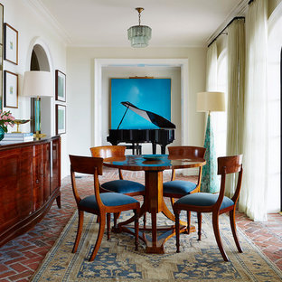 Example of a classic brick floor dining room design in Jacksonville with white walls