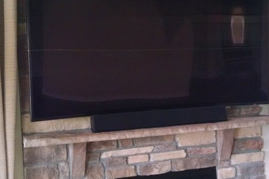 TV wall mount over stone fireplace