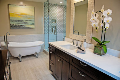 Example of a mid-sized eclectic master beige tile and ceramic tile porcelain tile and beige floor bathroom design in Los Angeles with shaker cabinets, dark wood cabinets, a one-piece toilet, beige walls, an undermount sink, quartz countertops, a hinged shower door and white countertops