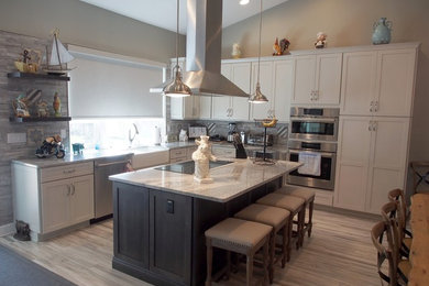 Inspiration for a large eat-in kitchen remodel in Tampa with shaker cabinets, white cabinets and an island