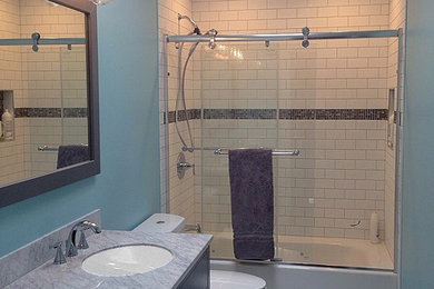 Example of a mid-sized transitional kids' white tile and ceramic tile ceramic tile alcove bathtub design in Chicago with shaker cabinets, dark wood cabinets, blue walls, an undermount sink and marble countertops