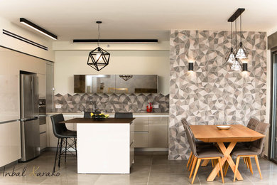 Inspiration for a mid-sized contemporary u-shaped gray floor kitchen remodel in Tel Aviv with a single-bowl sink, beige cabinets, gray backsplash, cement tile backsplash, stainless steel appliances and an island