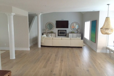 This is an example of a contemporary living room in Richmond with light hardwood floors.