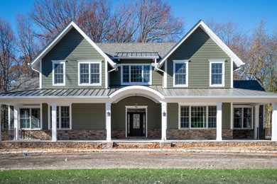 Large traditional green two-story concrete fiberboard and clapboard exterior home idea in New York with a mixed material roof and a brown roof