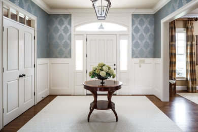 Traditional entryway in Louisville with blue walls, medium hardwood floors, a single front door, a white front door and brown floor.