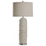 StyleCraft Home Collection - 39 Inch Ceramic Lamp In Bella Cream With Drum Shade - A look with a cool rustic quality, this ceramic table lamp is finished in a Bella cream tone. It features a tall body with a set of unique round accents that are lightly distressed to make them stand out. This body is topped with a taupe fabric hardback shade for a complete presentation.