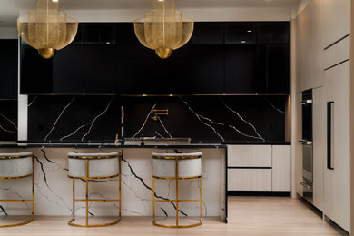 Inspiration for a modern l-shaped open concept kitchen remodel in Boston with an undermount sink, flat-panel cabinets, quartz countertops, quartz backsplash, paneled appliances and an island