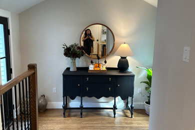 Inspiration for a mid-sized transitional light wood floor, brown floor and coffered ceiling hallway remodel in Boston with gray walls