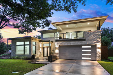Transitional mixed siding house exterior photo in Dallas with a hip roof and a mixed material roof