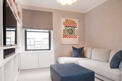 Inspiration for a contemporary enclosed carpeted living room remodel in New York with beige walls and a media wall
