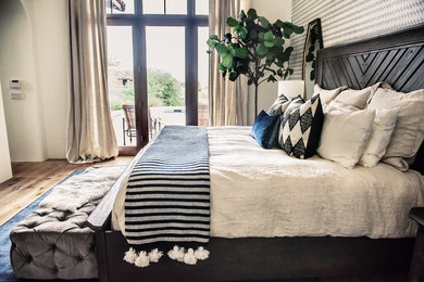 Bedroom - large transitional master light wood floor and beige floor bedroom idea in Phoenix with gray walls and a two-sided fireplace