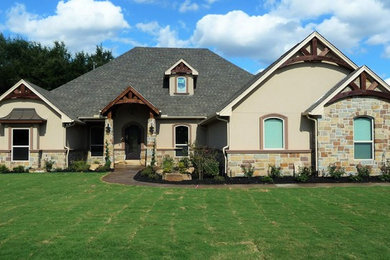 Example of a mid-sized classic beige two-story mixed siding exterior home design in Dallas with a hip roof
