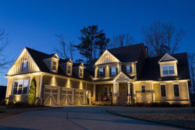 Large arts and crafts beige two-story mixed siding exterior home photo in Atlanta with a hip roof