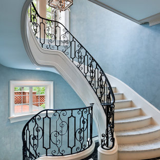 Design ideas for a large traditional curved metal railing staircase in Philadelphia with wood risers and marble treads.