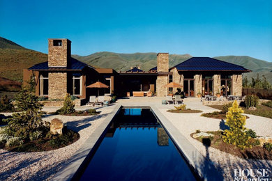 Large mediterranean brown one-story stone exterior home idea in Boise
