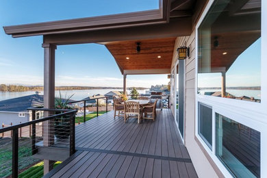 Large transitional back porch photo in Portland with decking and a roof extension