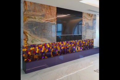 A modern luxury TV wall in a minimalist living room. The wall features an elegan