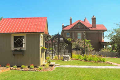 Inspiration for a mid-sized traditional full sun side yard stone landscaping in Other.