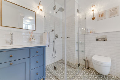 オレンジカウンティにある高級なコンテンポラリースタイルのおしゃれな浴室 (壁掛け式トイレ、白いタイル、白い壁、セラミックタイルの床、グレーの床、開き戸のシャワー、白い洗面カウンター) の写真
