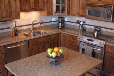 Inspiration for a mid-sized craftsman l-shaped porcelain tile eat-in kitchen remodel in Chicago with an undermount sink, shaker cabinets, medium tone wood cabinets, solid surface countertops, beige backsplash, ceramic backsplash, stainless steel appliances and an island
