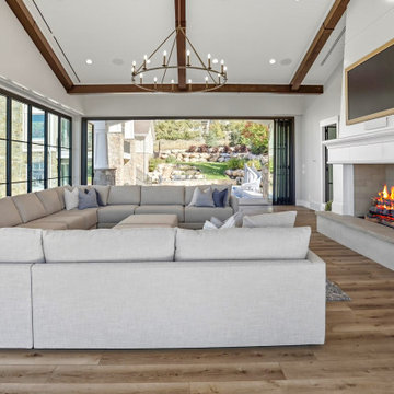 Open Folding Glass Doors Connect the Living Room to the Landscaped Pool Yard
