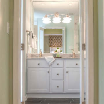 Hallway leads to new bath thru frosted glass doors