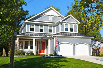 Example of a transitional blue two-story house exterior design in Cincinnati with a mixed material roof