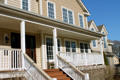 Large classic front porch idea in Chicago with decking and a roof extension