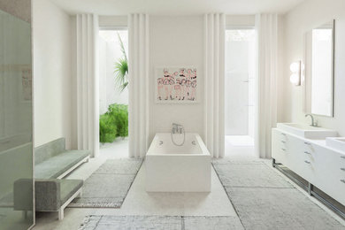Diseño de cuarto de baño principal contemporáneo grande con encimeras blancas, bañera exenta, ducha esquinera, baldosas y/o azulejos blancos, paredes blancas, suelo de cemento, lavabo tipo consola, suelo gris y ducha con puerta con bisagras
