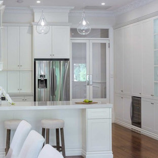 Large traditional kitchen pantry designs - Kitchen pantry - large traditional u-shaped medium tone wood floor and beige floor kitchen pantry idea in Hobart with a farmhouse sink, shaker cabinets, white cabinets, granite countertops, white backsplash, subway tile backsplash, stainless steel appliances, no island and white countertops