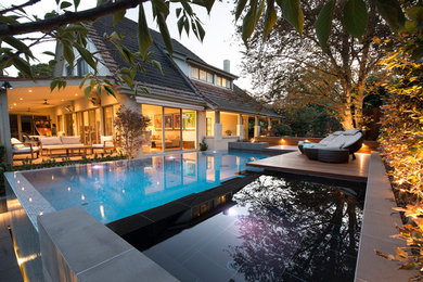 Photo of a mid-sized contemporary backyard infinity pool in Melbourne.