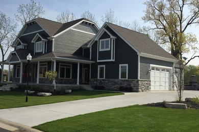 Large craftsman gray two-story concrete fiberboard house exterior idea in Chicago with a hip roof and a shingle roof