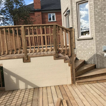 Upper deck with wood railings and finished skirting above the lower deck in Mark