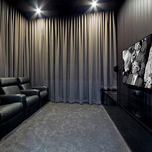 Mid-sized trendy enclosed carpeted home theater photo in Brisbane with black walls and a wall-mounted tv