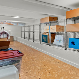 Inspiration for a bohemian fully buried basement in San Francisco with white walls, cork flooring and brown floors.
