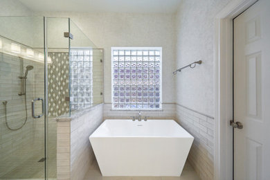 Mid-sized trendy master white tile and ceramic tile ceramic tile, white floor, double-sink, coffered ceiling and wallpaper bathroom photo in Houston with raised-panel cabinets, white cabinets, a two-piece toilet, white walls, an undermount sink, granite countertops, a hinged shower door, gray countertops and a built-in vanity