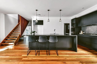 Inspiration for a mid-sized contemporary single-wall kitchen pantry in Brisbane with a drop-in sink, flat-panel cabinets, grey cabinets, concrete benchtops, ceramic splashback, stainless steel appliances, medium hardwood floors, with island, brown floor and grey benchtop.