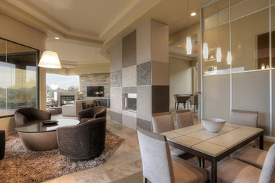 Inspiration for a large modern open concept ceramic tile family room remodel in Phoenix with gray walls, a two-sided fireplace, a plaster fireplace and a wall-mounted tv