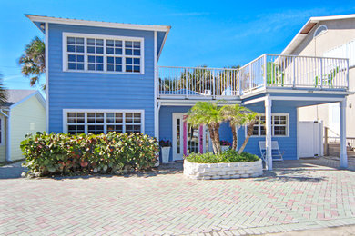 Inspiration for a beach style two-storey blue house exterior in Orlando.
