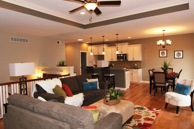 Living room - mid-sized contemporary open concept light wood floor living room idea in Chicago with beige walls