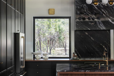 Kitchen - large kitchen idea in Austin with black cabinets and an island