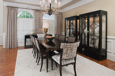 Great room - mid-sized medium tone wood floor great room idea in Atlanta with beige walls and no fireplace