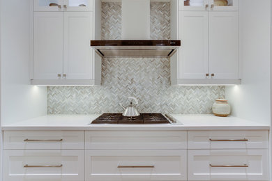 Inspiration for a mid-sized transitional galley medium tone wood floor kitchen remodel in Toronto with an undermount sink, shaker cabinets, white cabinets, quartz countertops, gray backsplash, stone tile backsplash, stainless steel appliances and no island