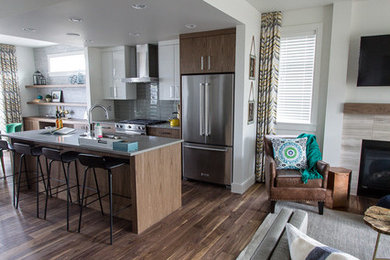 Kitchen - contemporary dark wood floor kitchen idea in Vancouver with gray backsplash, glass tile backsplash, stainless steel appliances and an island