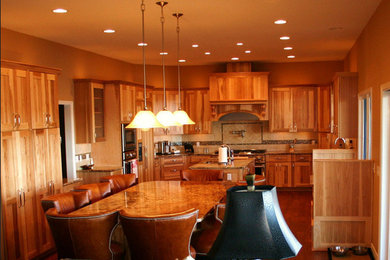 Inspiration for a mid-sized rustic u-shaped dark wood floor and brown floor eat-in kitchen remodel in Other with shaker cabinets, medium tone wood cabinets, granite countertops, beige backsplash, ceramic backsplash, stainless steel appliances and two islands