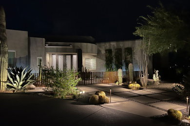 Photo of a mid-sized drought-tolerant and full sun front yard concrete paver and metal fence garden path in Phoenix for winter.