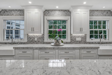 Example of a classic kitchen pantry design in New York with a farmhouse sink, recessed-panel cabinets, white cabinets, quartz countertops, paneled appliances and an island